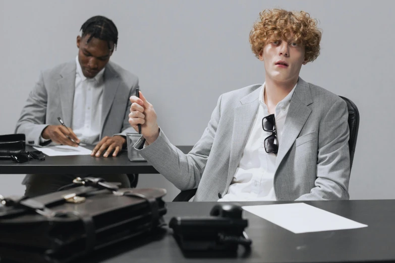 a man and a woman sitting at a table with a briefcase