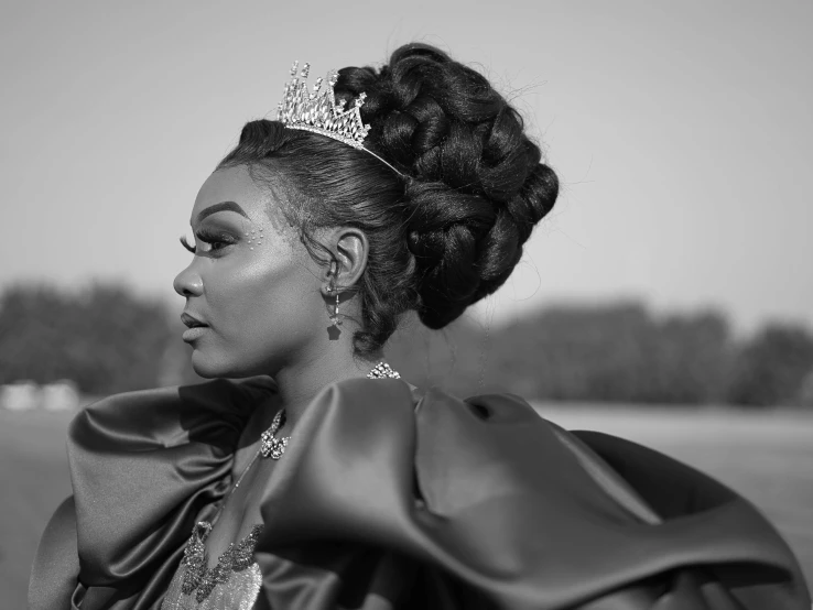 black and white pograph of woman in a dress with crown