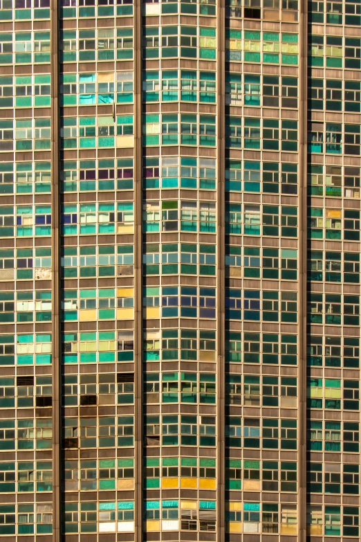 many multi - colored squares on a building with a man