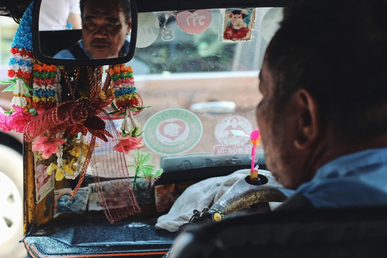 an older person looks out of a window at a street vendor