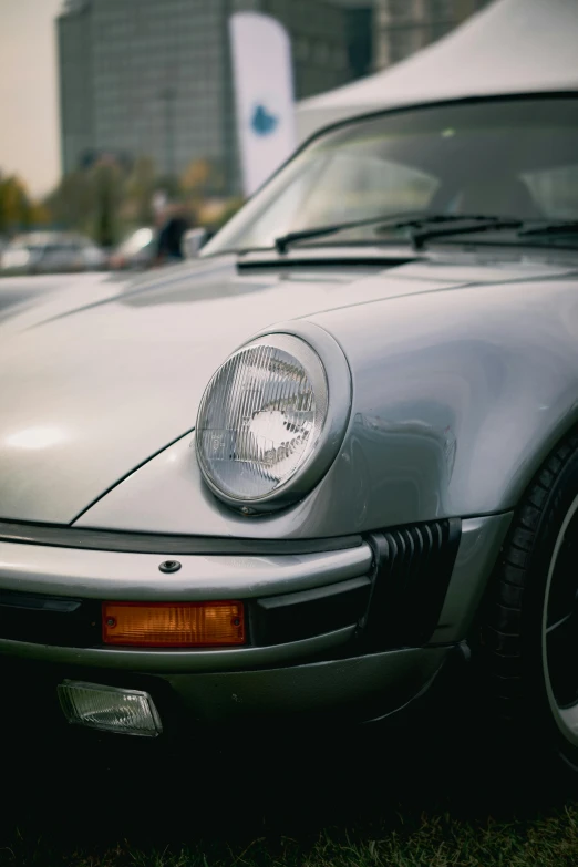 a small white sports car parked in front of a building