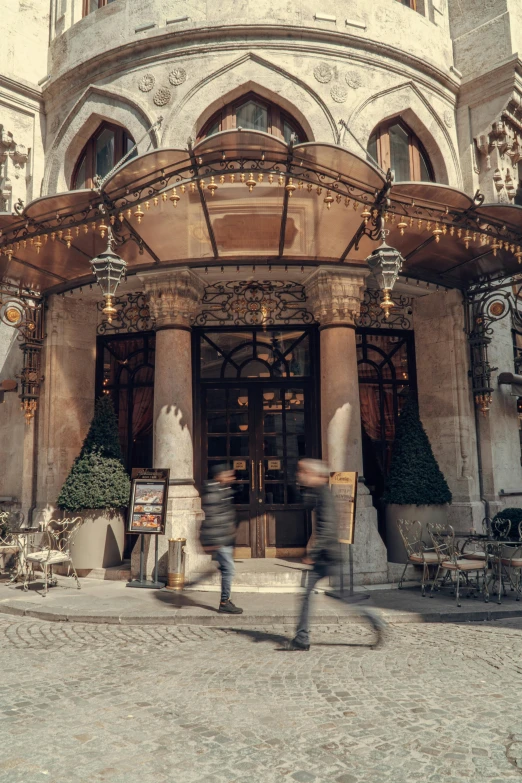 a tall building with ornate doors and a clock on the front