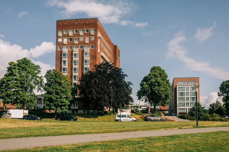 the building is brick and there is cars parked in front