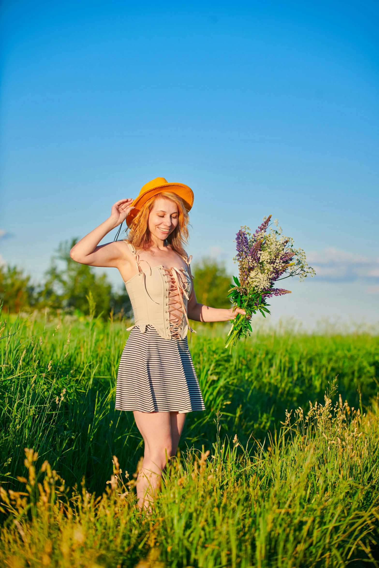 a girl in a field with some flowers
