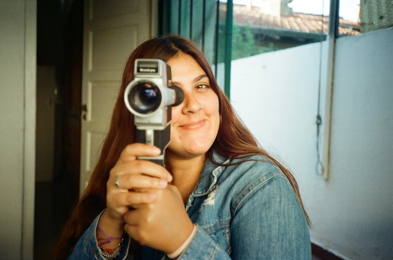 a woman takes a picture with her camera phone