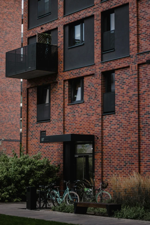 a large building with several windows and a bike parked against the wall