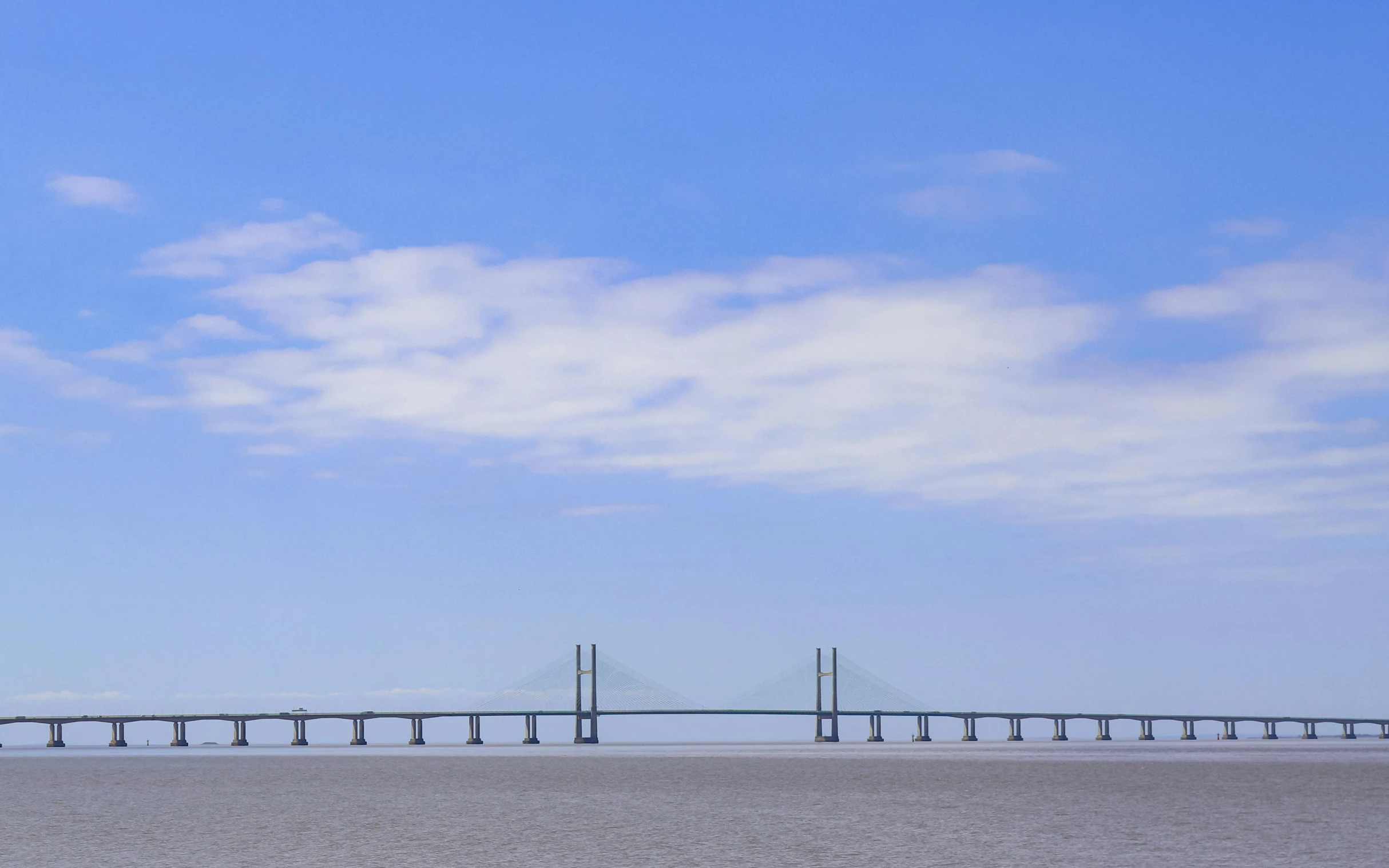 a po of a large bridge with a few clouds in the sky