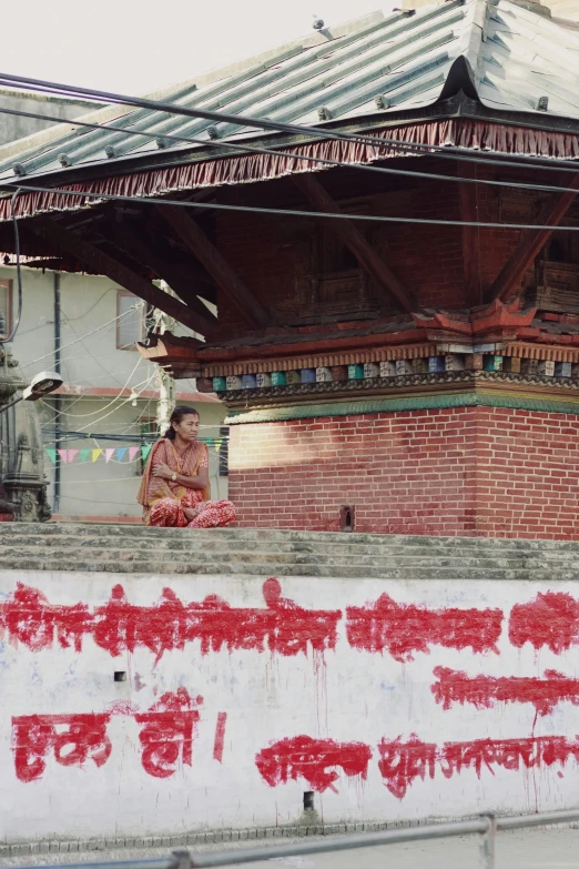 a man on the top of a roof near a sign