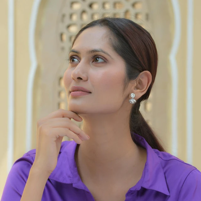 a woman in purple is posing for the camera