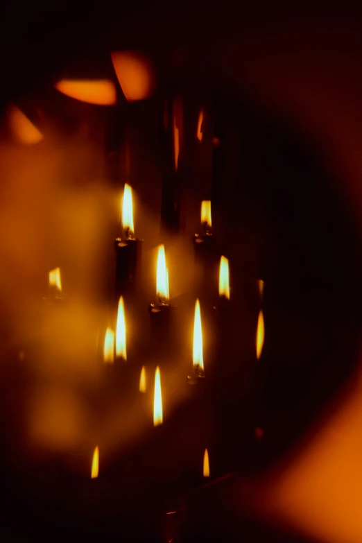 several candles that are lit and glowing on a dark background