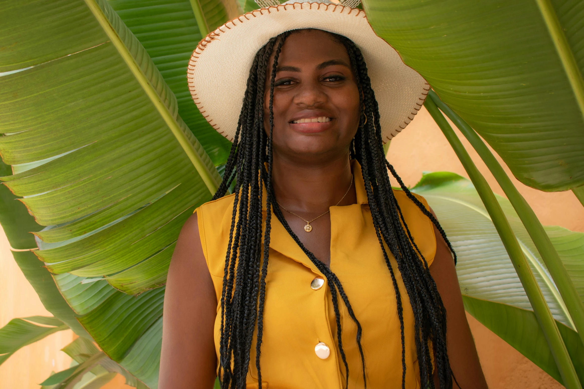 a young woman wearing a straw hat with big ids