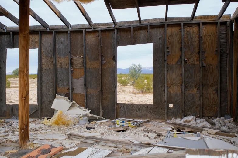 an empty room with broken windows and rocks scattered around