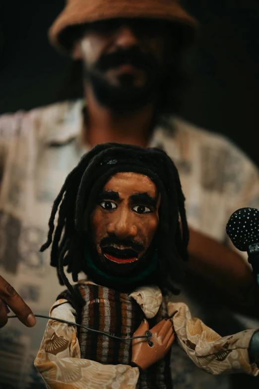 a stuffed toy head of a man with dreads