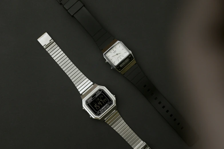 a close up of two watches on the table