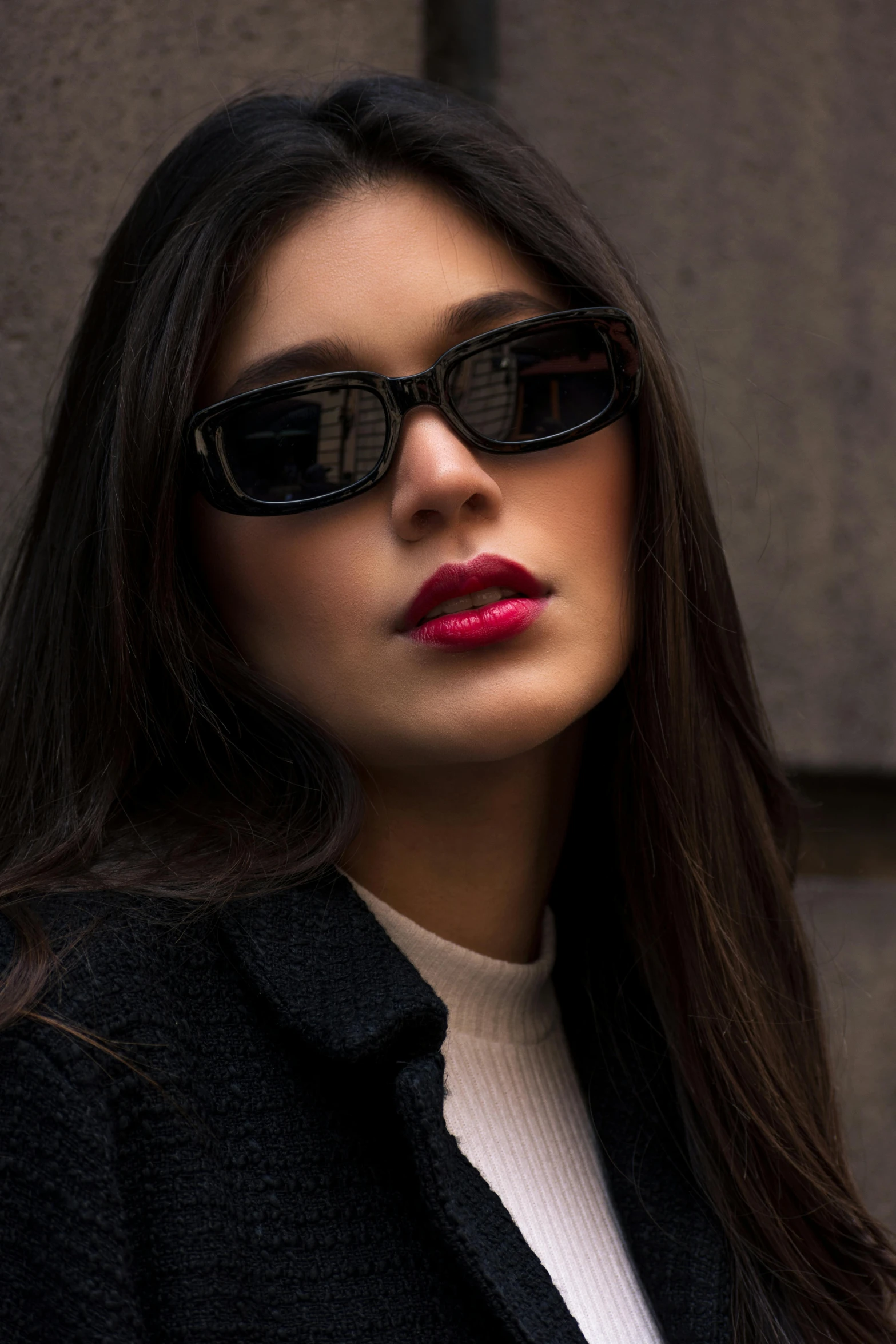 an attractive woman wearing sunglasses is posing for the camera