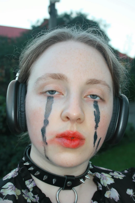 girl with black and white painted makeup on headphones