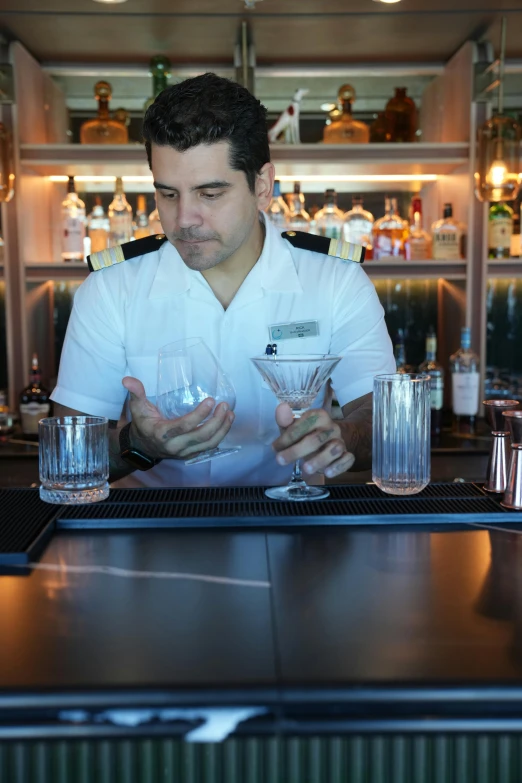 a bartender is in the process of making an alcoholic drink