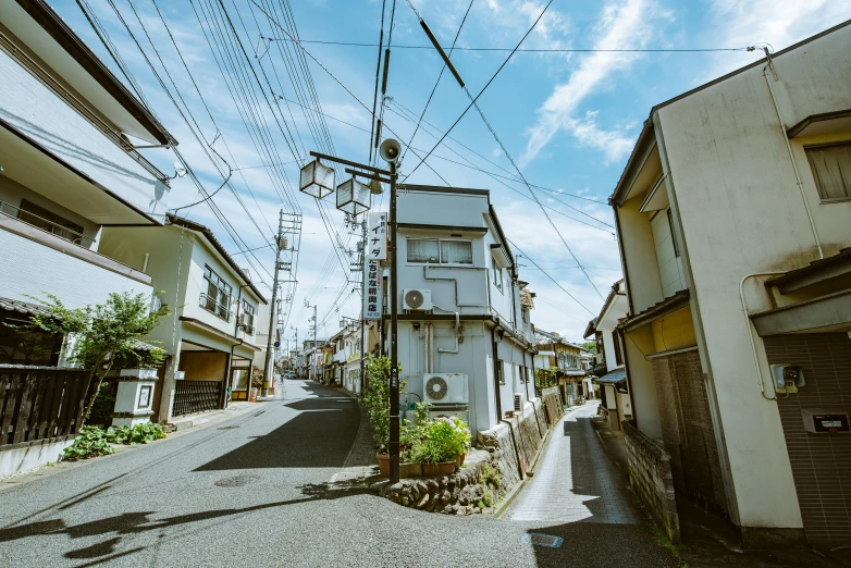 a person walking down an alleyway with power lines above them