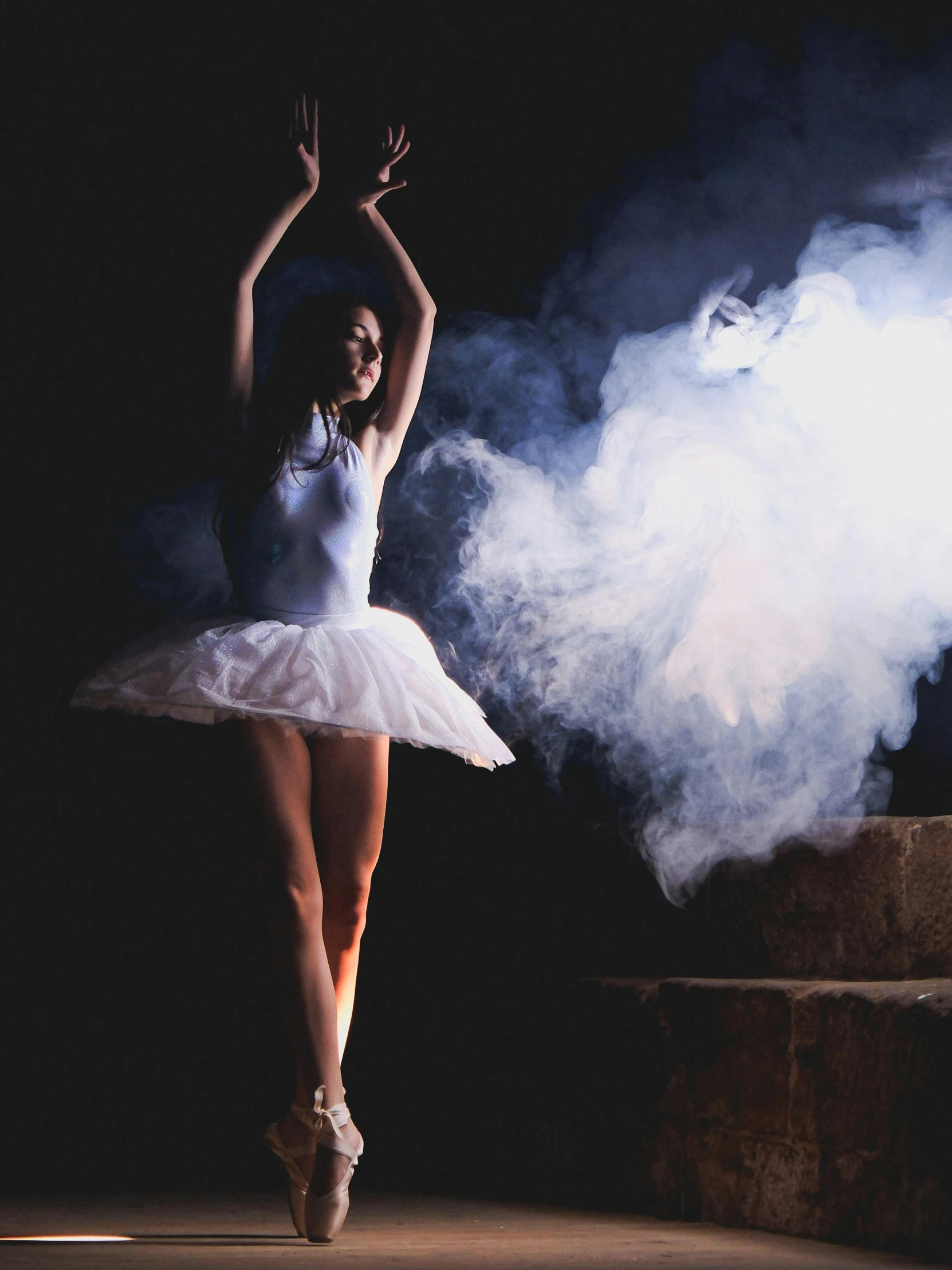 a ballerina in white clothes is posing for the camera