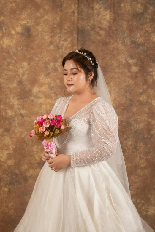 a bride poses for the camera while holding a bouquet