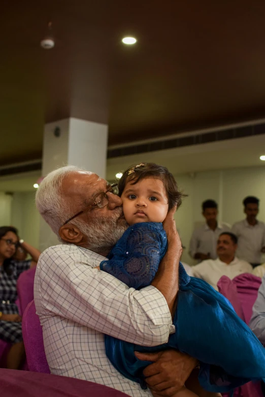 a father and his little daughter giving him a hug