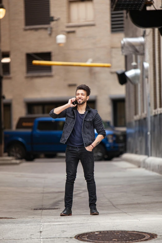 a man standing in the middle of a street with a phone