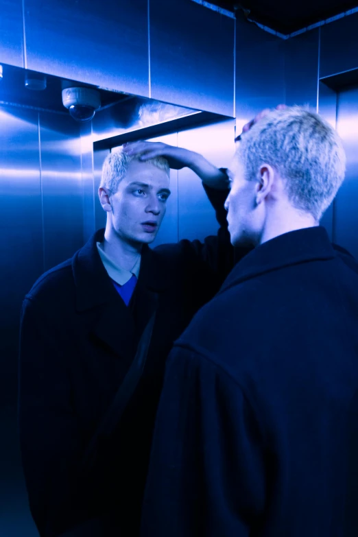 the two men have their hair combed at night