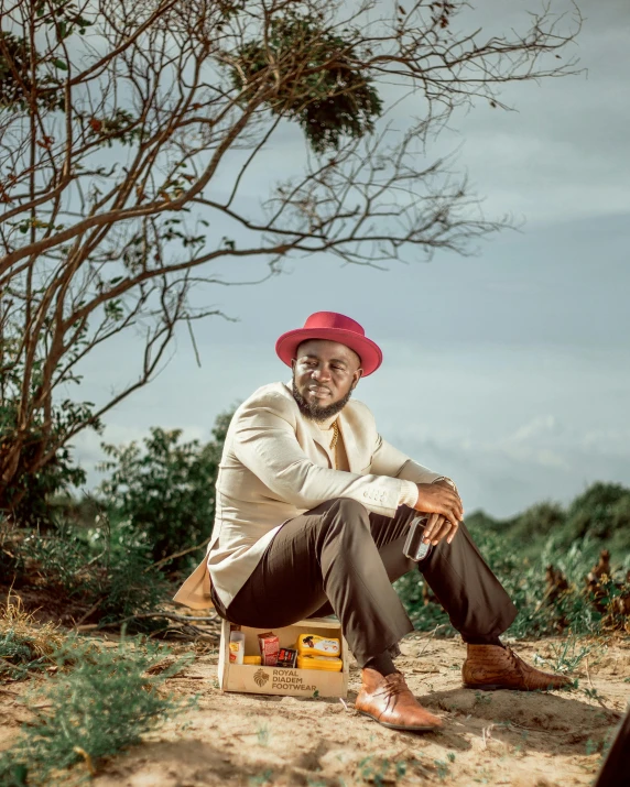 a man is sitting on the bench in a red hat