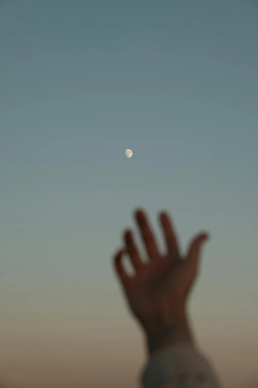 a hand that is reaching to the sky