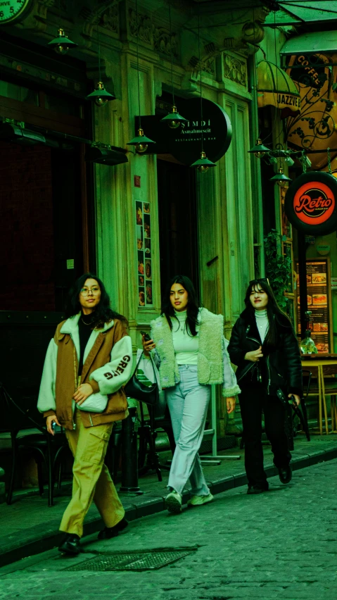 a group of women are walking down the street