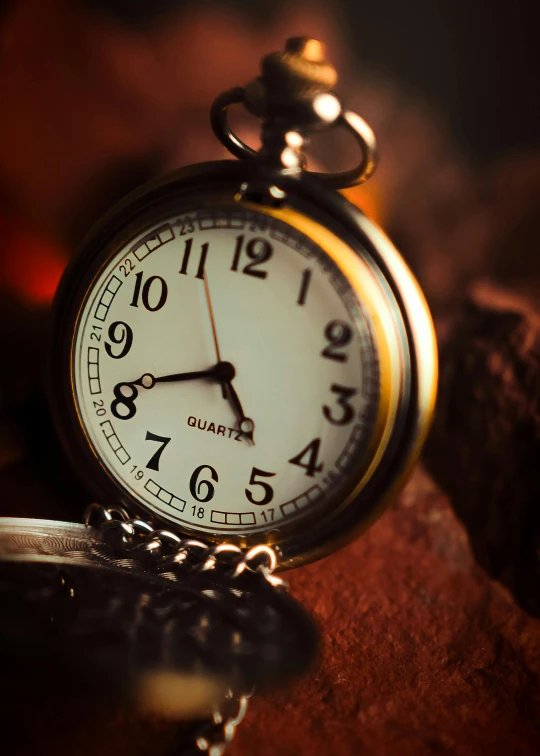 there is an old watch that is sitting on the table