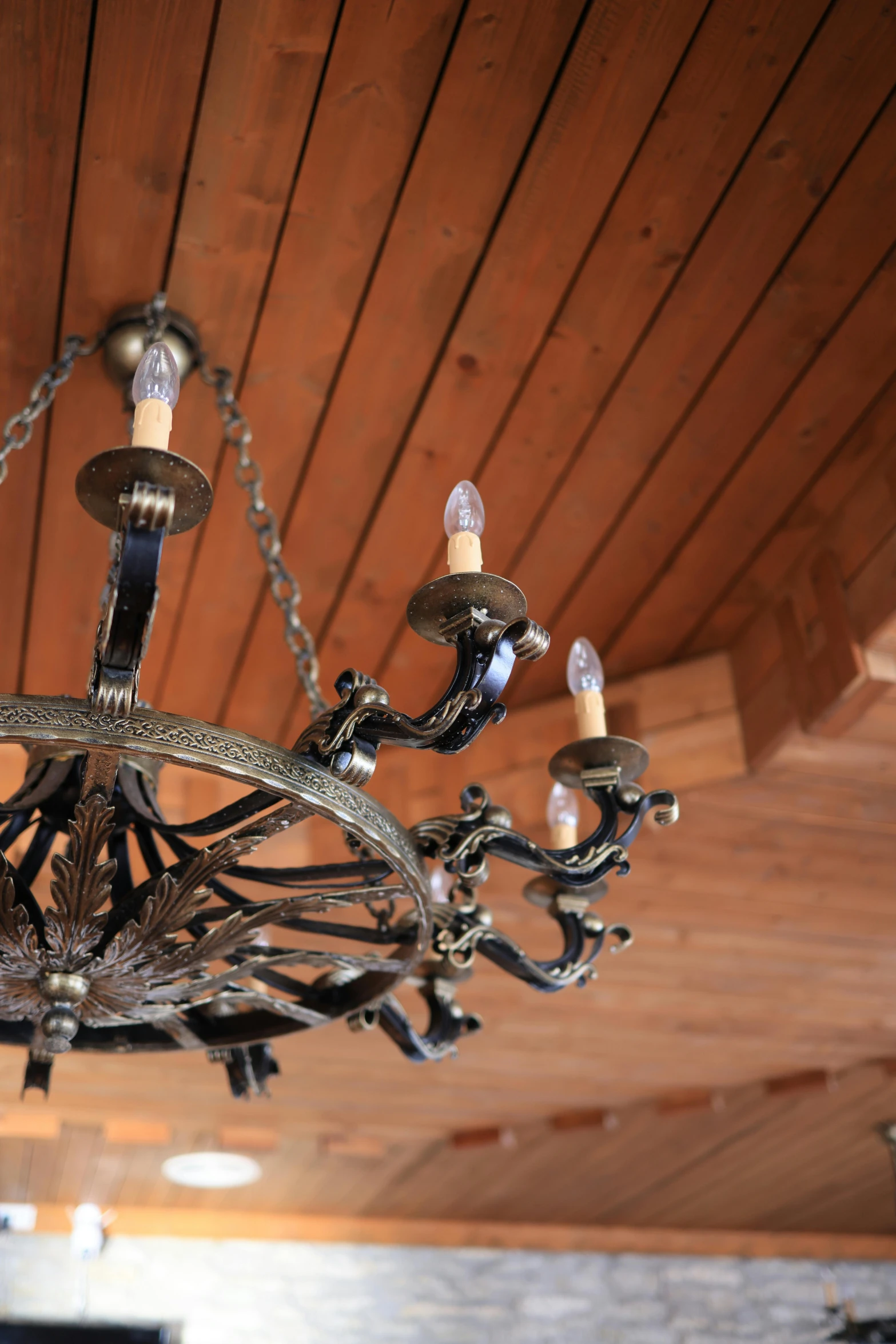 a ceiling with wooden boards and chandelier in it