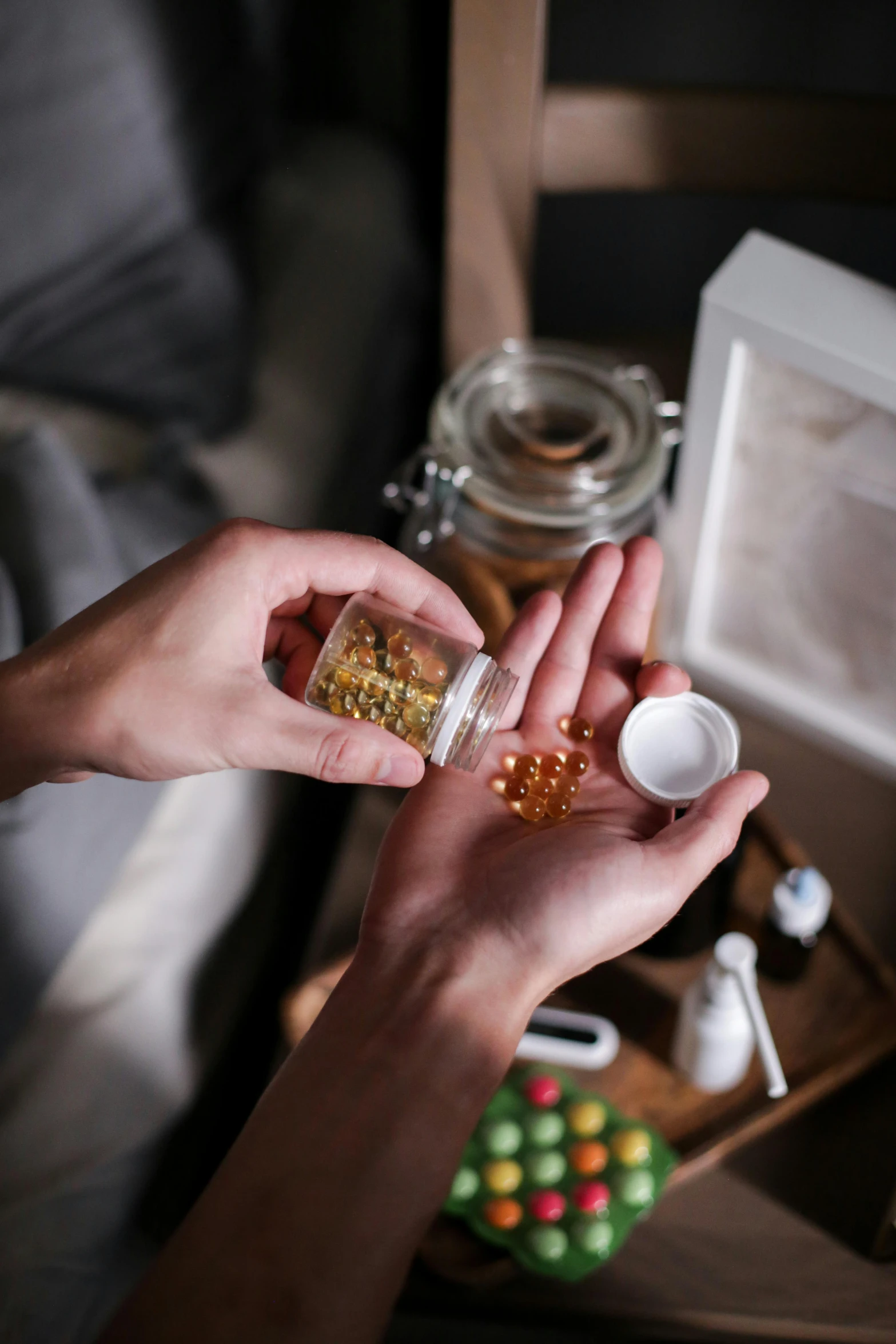 a person holding a jar full of pills