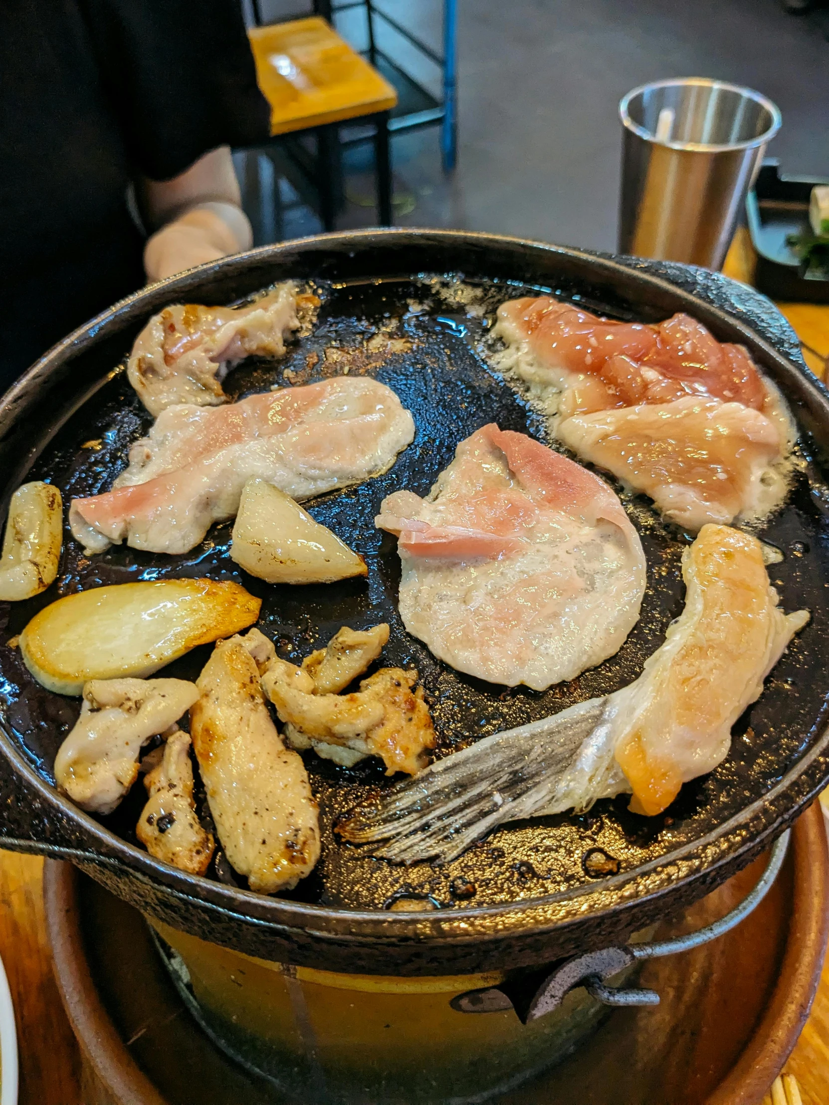 a close up of a pan on a table with various meats