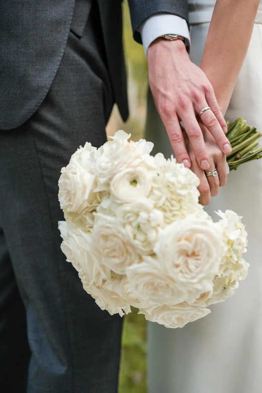 the wedding couple has white flowers in their bouquets