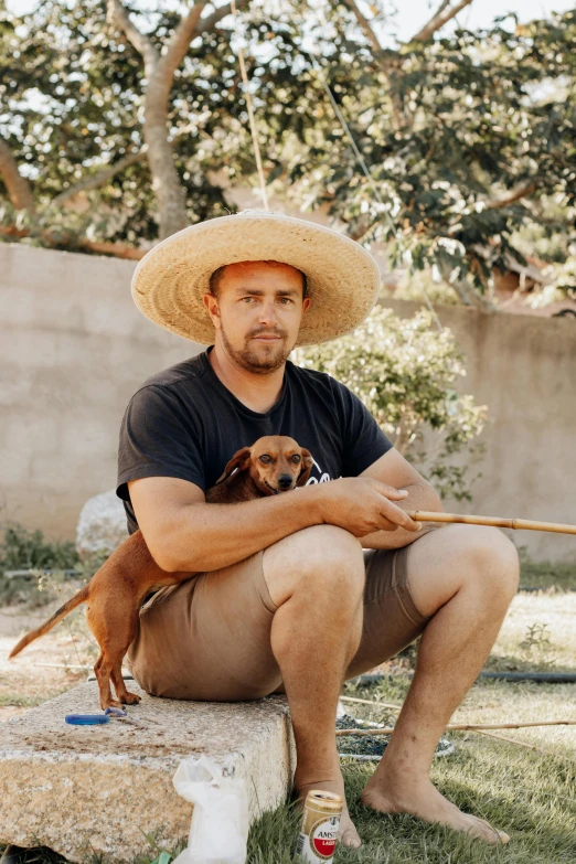 a man holding a dog on a stick outside