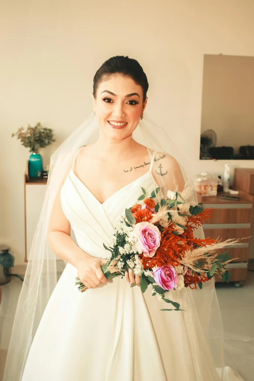 bride holding pink and white bridal bouquet