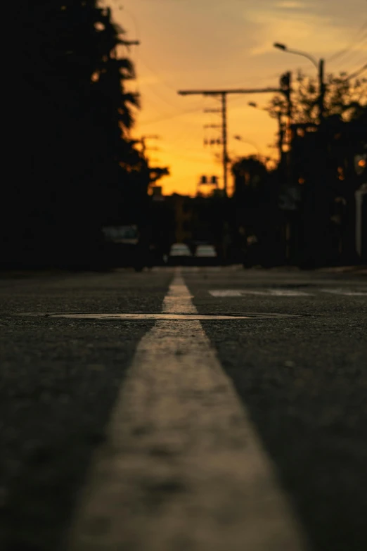 a very long shadow on the ground of a street