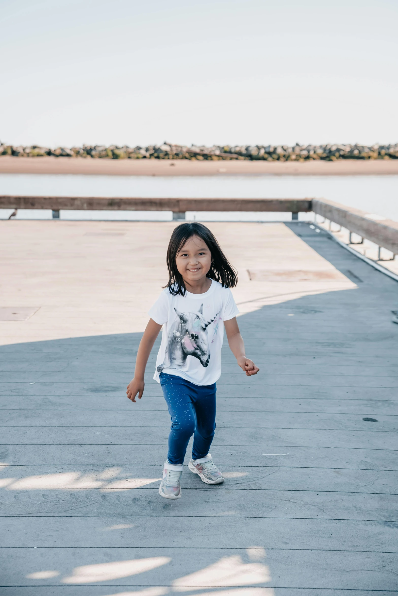 the  smiles as she runs down the pier path