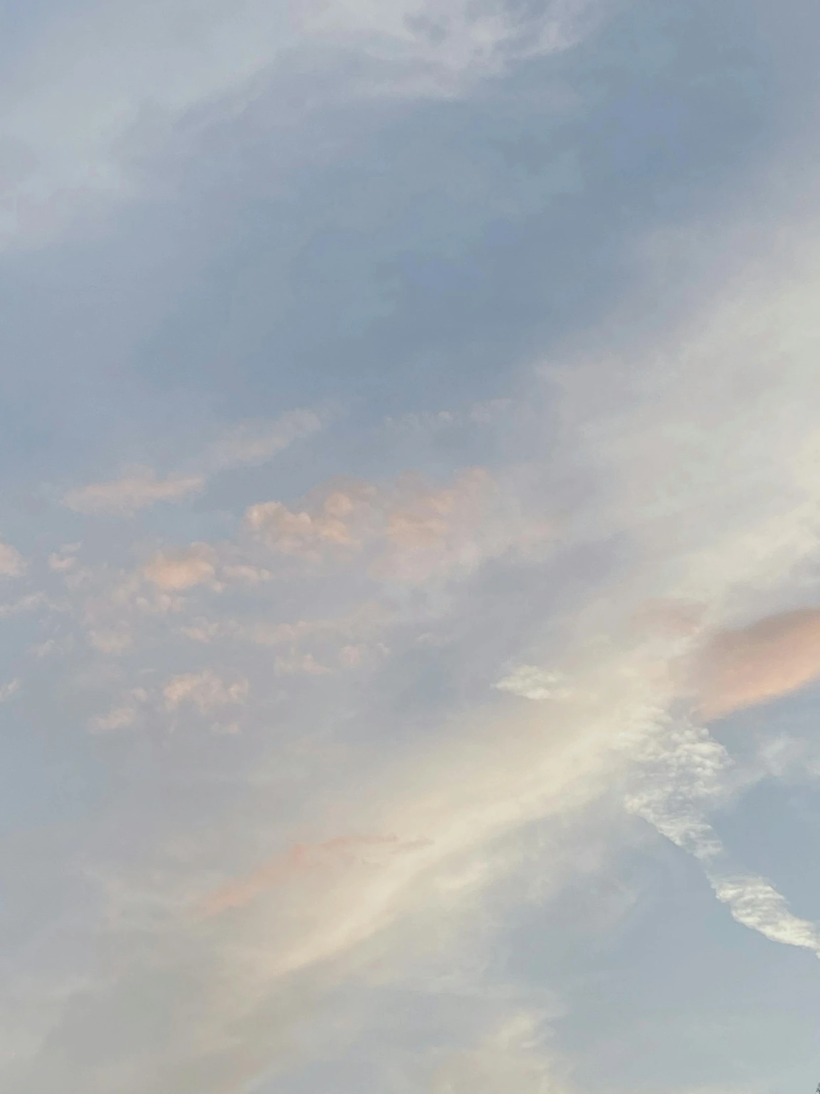 a lone airplane is soaring under the clouds