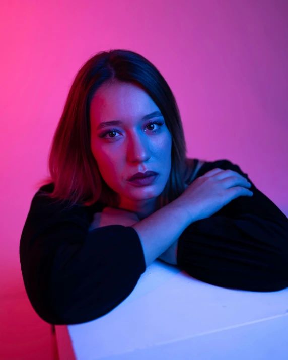 an attractive young woman posing with her arms crossed