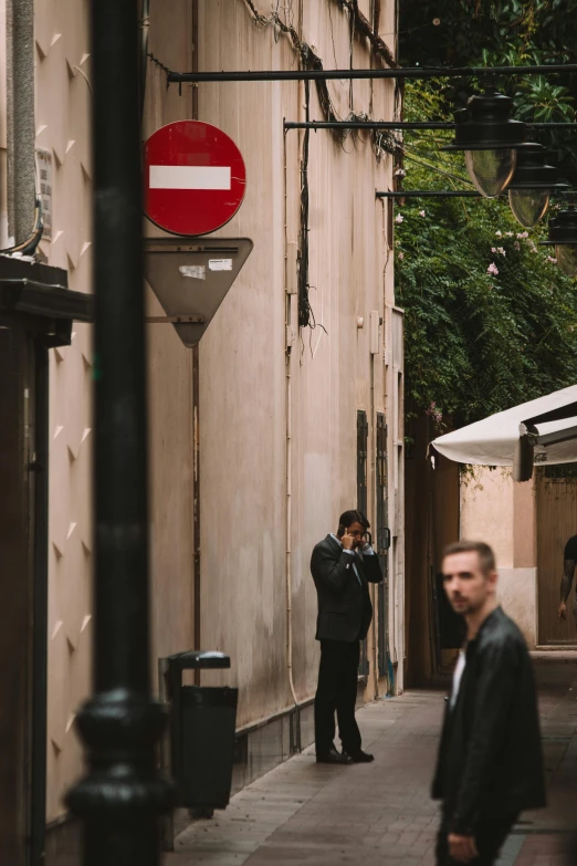 a street corner with a stop sign hanging on the wall