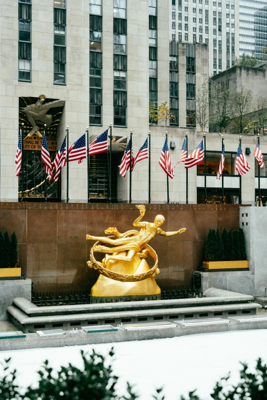 a gold statue with american flags in the background