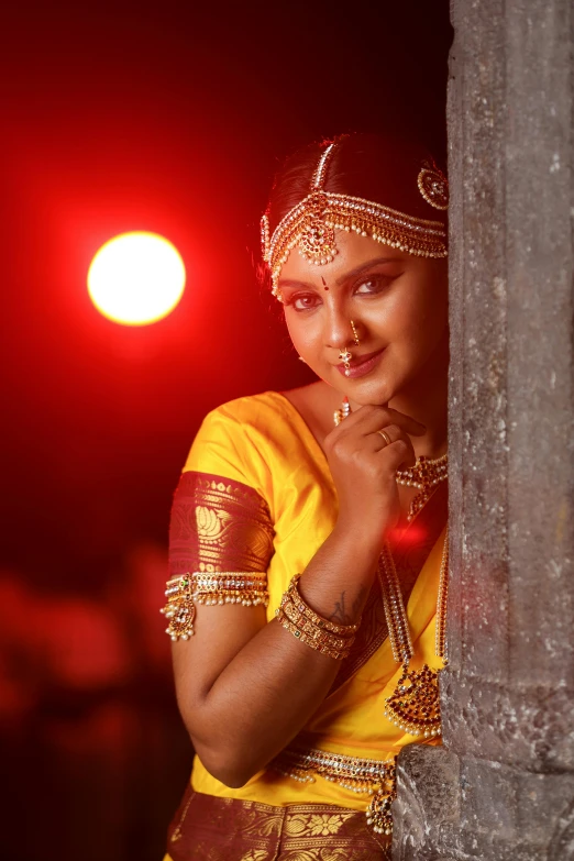 a woman in traditional indian garb posing for the camera