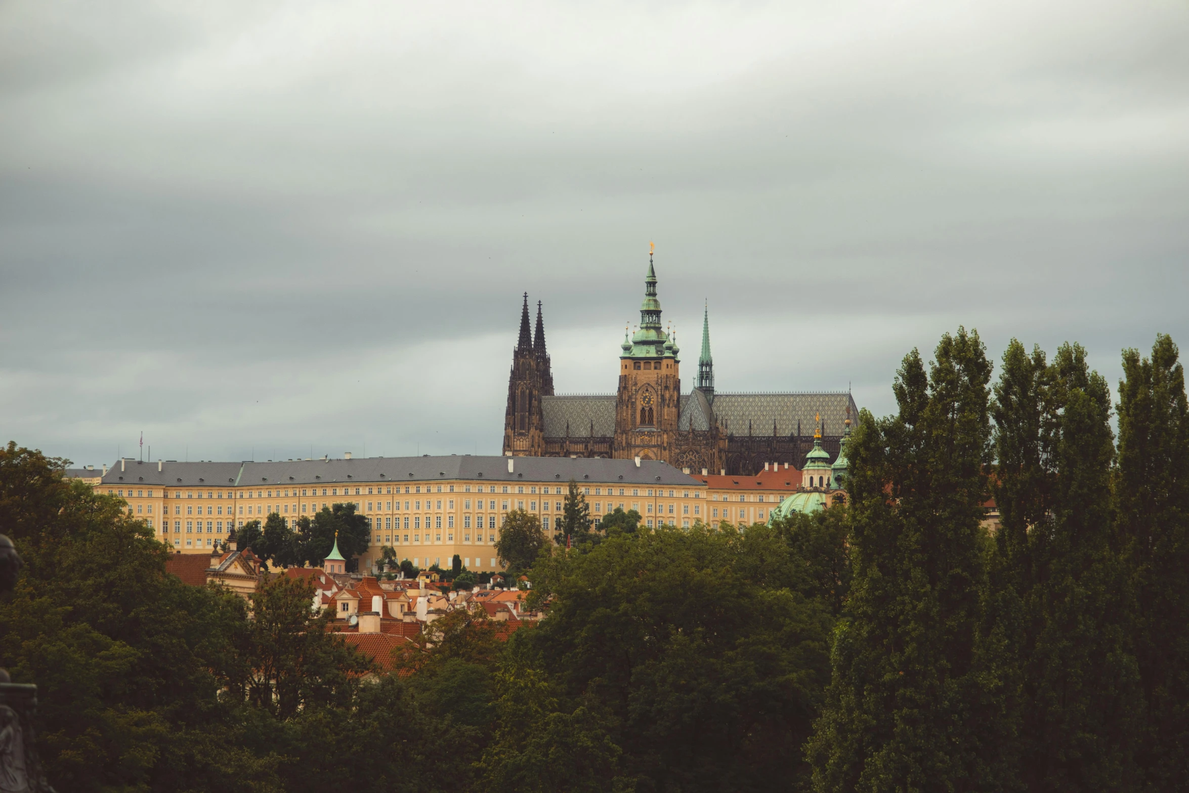 a large building on the top of a hill with towers