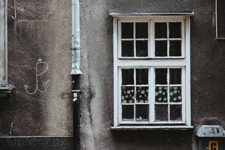 a wall with a window, street light, and a lamp post