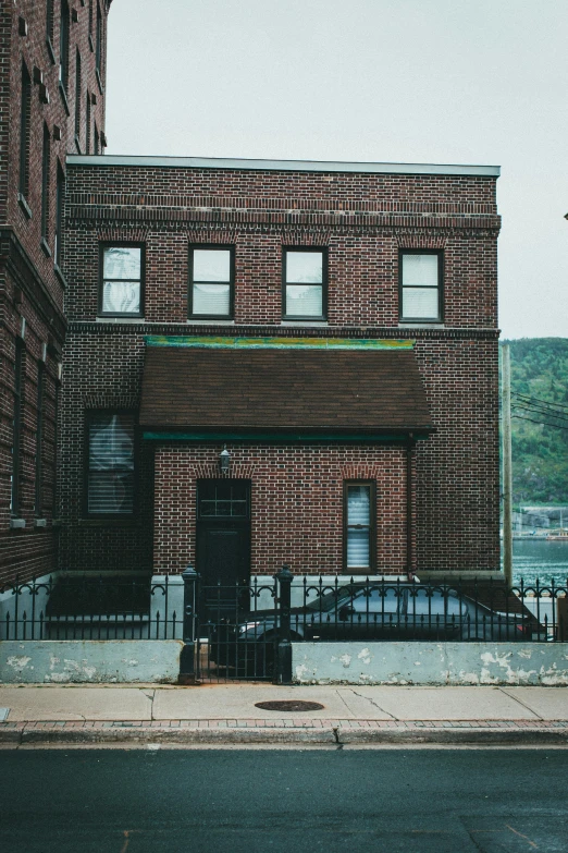 a brick building with a fence around it