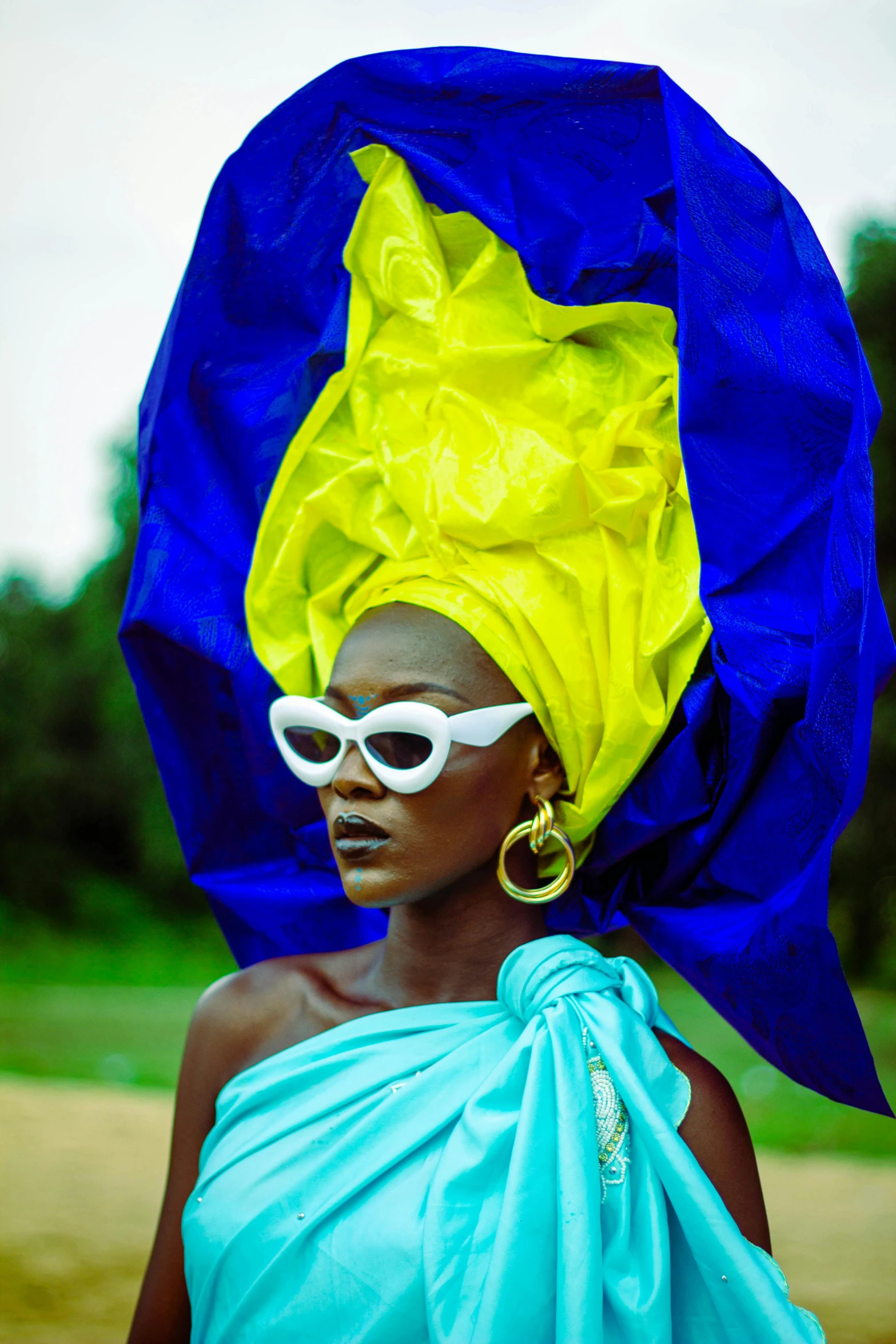 a person wearing a blue and yellow head scarf