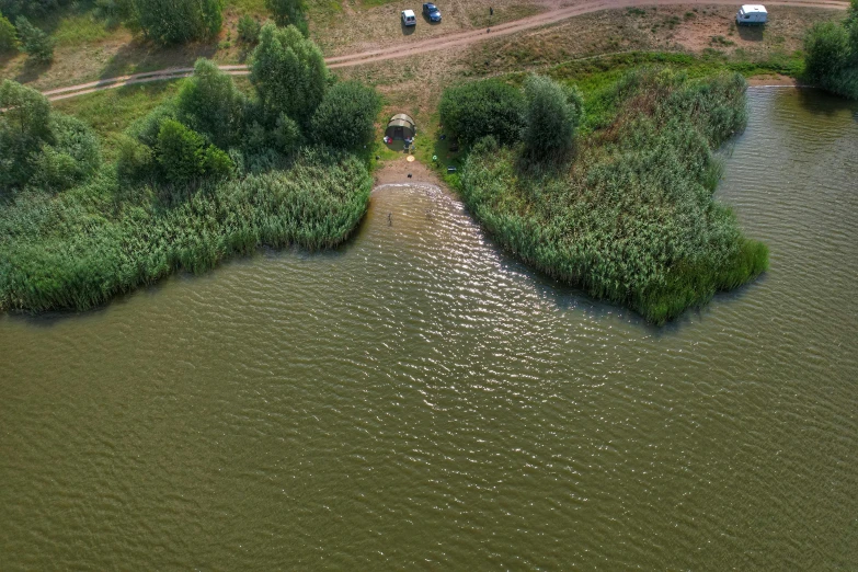 an aerial view of cars parked at the end of the water