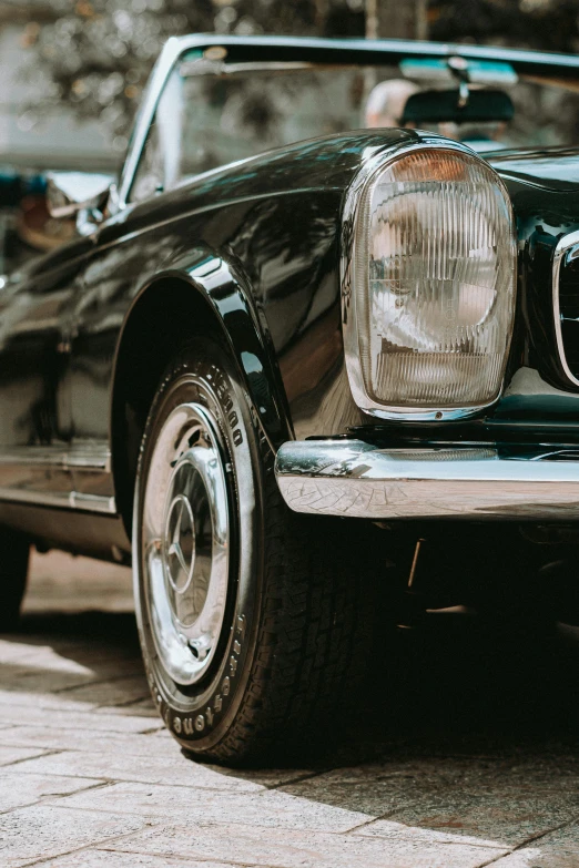 the headlights and bumpers of a black car are shown